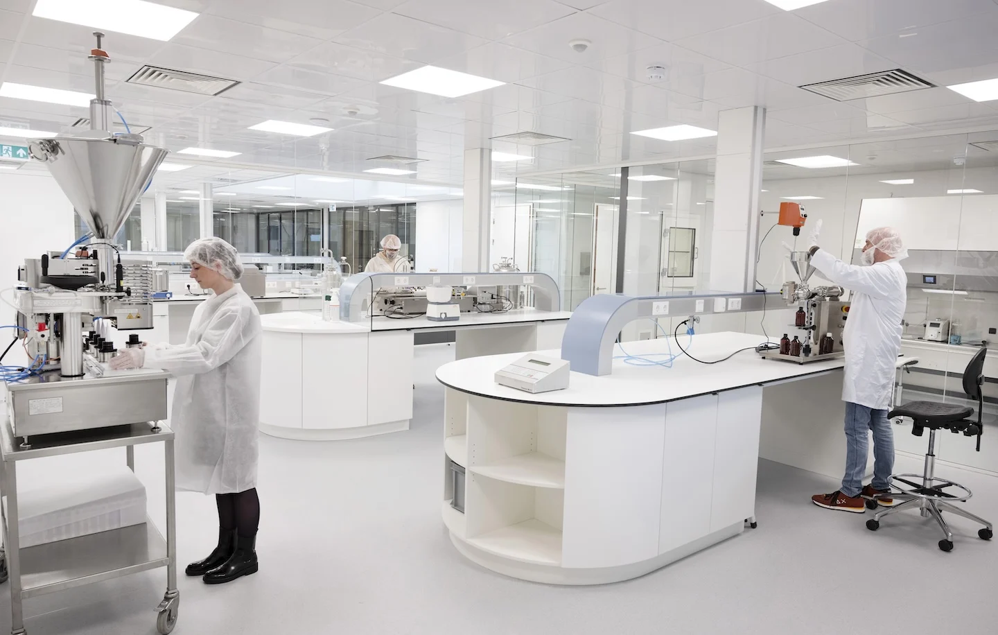 Laboratory staff working in a modern pharmaceutical compounding room